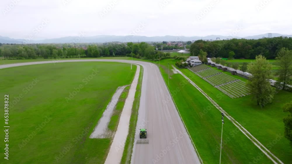 Race Field in Slovenia tractor leveling the sand Race Field in Slovenia tractor leveling the sand