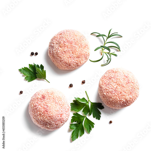 Raw cutlets or meatballs with parsley and pepper photo