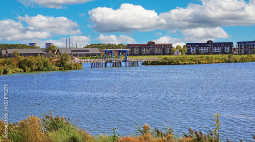 Wallpaper Mural Thorn (Maasresidence), Netherlands - September 24. 2023: Beautiful lake at river Maas with new luxury vacation resort Torontodigital.ca