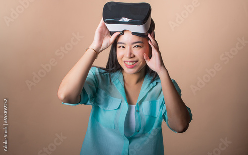 Asian beautiful woman wearing VR glass, presenting environmental sustainable issue, smiling with happiness on isolated background, copy space. Environmental saving, Technology concept.