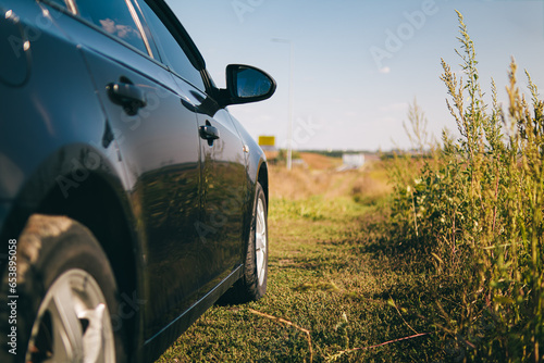 Automotive theme.Rent a car.Car side view mirror.View of the side of the car body.The auto is in a beautiful place.Car mirror.Auto enthusiast.quality photo.Wallpapers.auto theme. auto in the field.