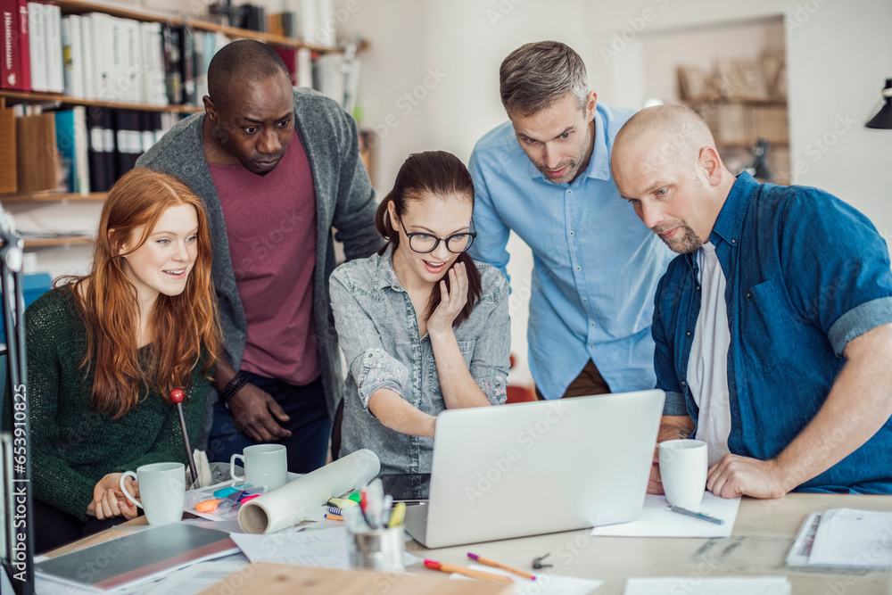 Group of people working together on a project in a startup company office Group of people working together on a project in a startup company office