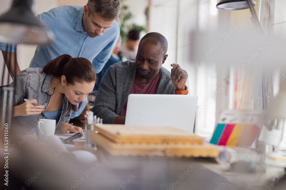 Group of people working together on a project in a startup company office Group of people working together on a project in a startup company office