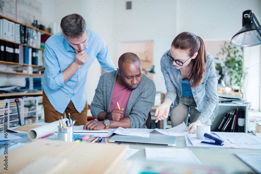 Group of people working together on a project in a startup company office Group of people working together on a project in a startup company office