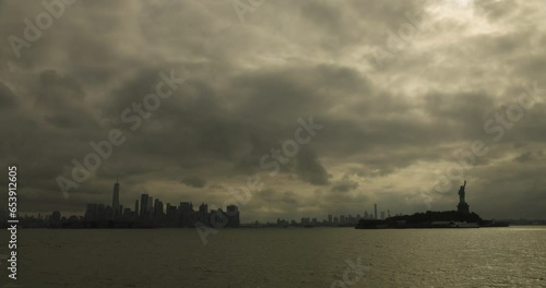 Statue of Liberty and Downtown NYC on Warm Cloudy Morning