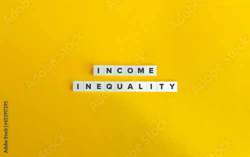 Income Inequality, Economic Disparity, Income Gap Concept Image and Banner.\
\
Letter Tiles on Yellow Background. Minimal Aesthetics.