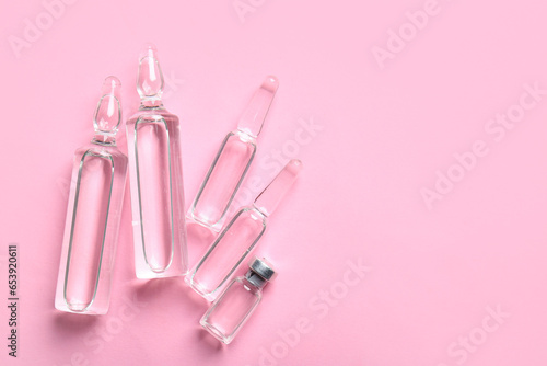 Medical ampules on pink background