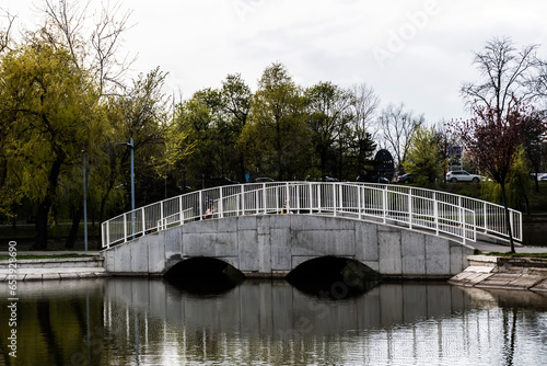 Pedestrian bridge in Bordei park over the lake. Bucharest, Romania. photo