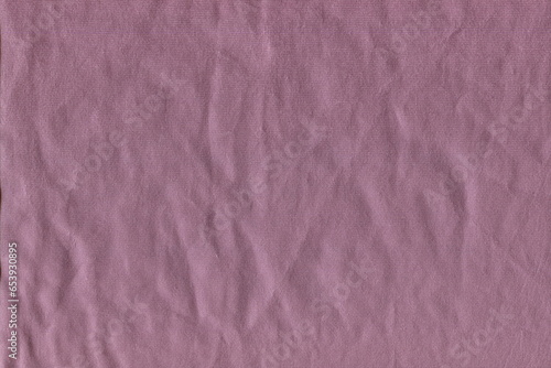 The texture of soft natural fabric is a pleasant pink color. Soft homemade napkin, pleasant to the touch. Home textiles. Fabric background.