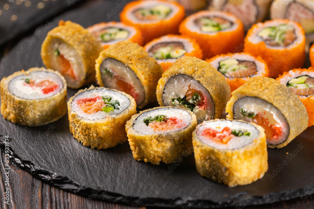Japanese salmon sushi - Sushi menu norimaki and uramaki. Asian cuisine concept Japanese salmon sushi - Sushi menu norimaki and uramaki. Asian cuisine concept