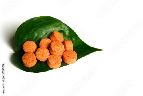 Vitamin-C tablets with white background.
