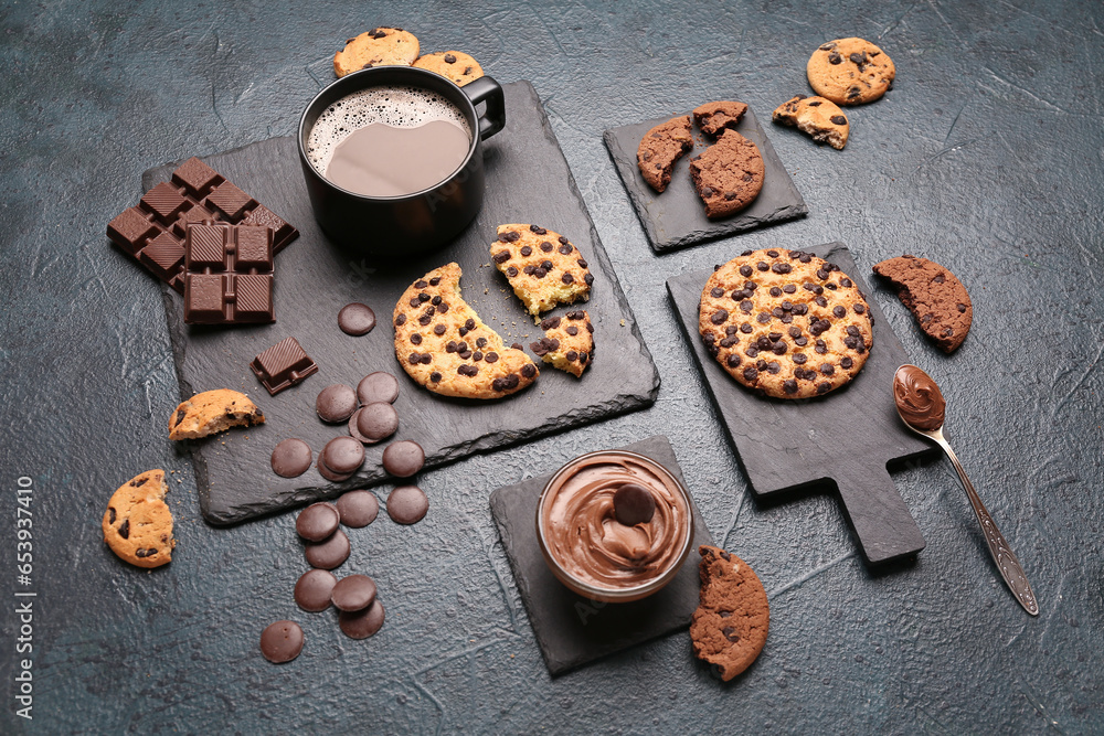 Cup of coffee with cookies, chocolate and boards on dark grunge table Cup of coffee with cookies, chocolate and boards on dark grunge table