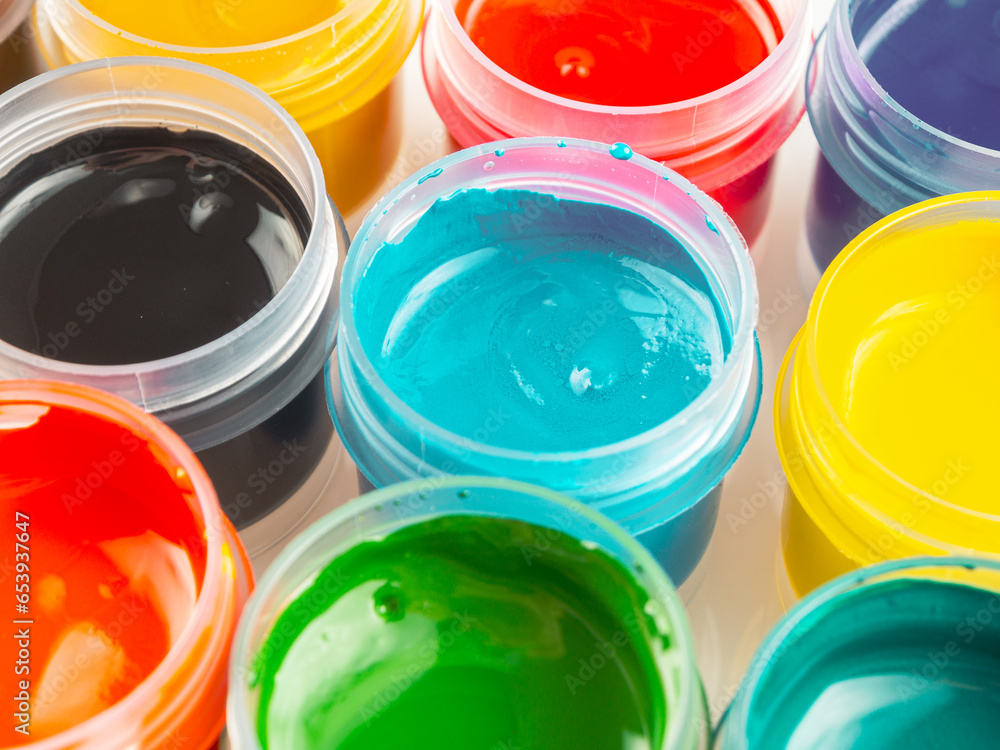 Jars of acrylic gouache paint art painting creativity and development close-up Jars of acrylic gouache paint art painting creativity and development close-up