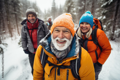 Portrait of group of senior friends having fun together outdoors in winter.