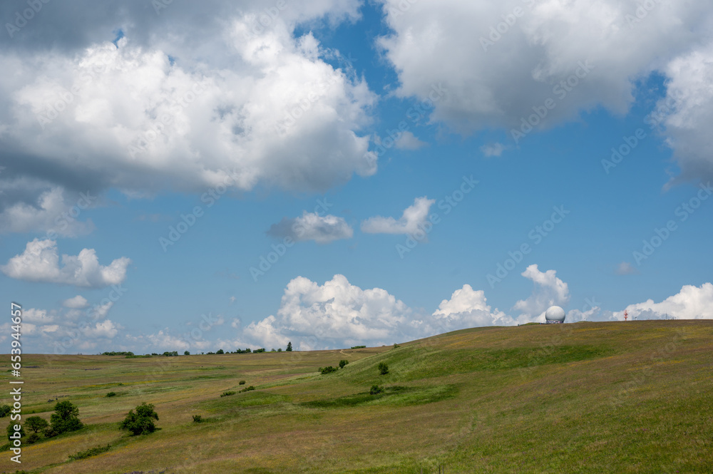 Radome (antenna dome) on the Wasserkuppe with a meadow and blue sky