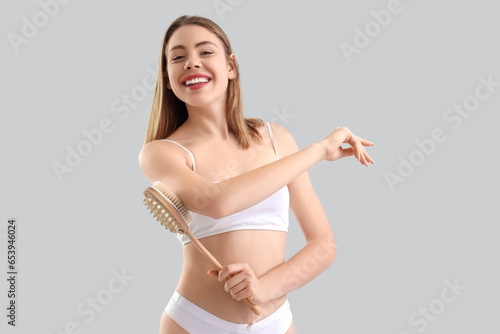 Young woman massaging her a...