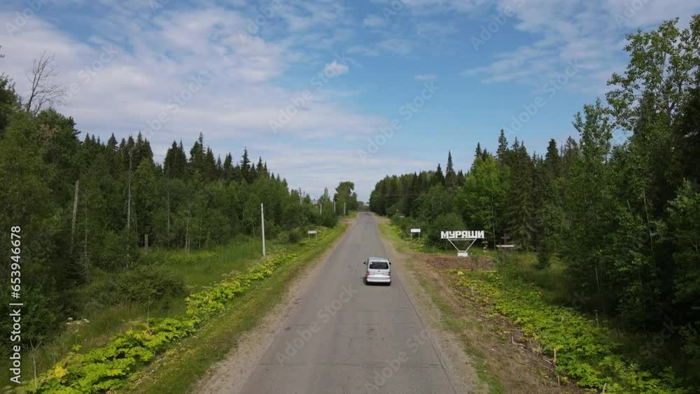 Empty road between green trees Empty road between green trees