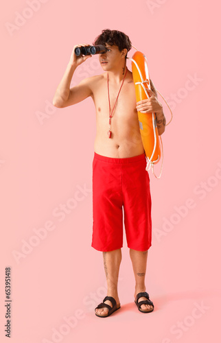 Male lifeguard with binocul...