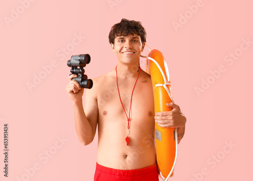 Male lifeguard with binocul...