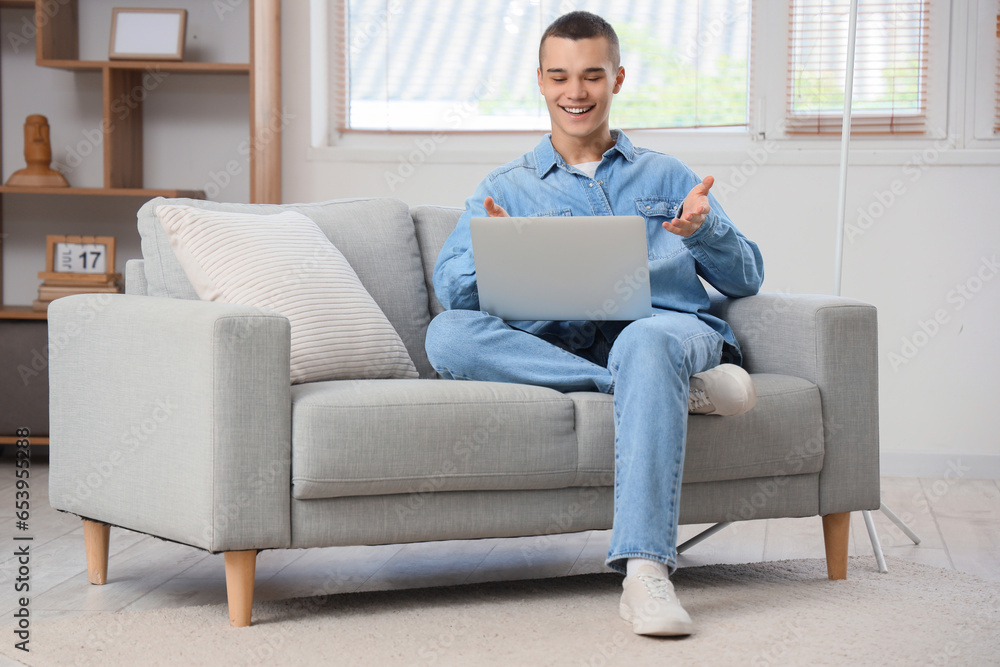 Young man with laptop video chatting at home Young man with laptop video chatting at home