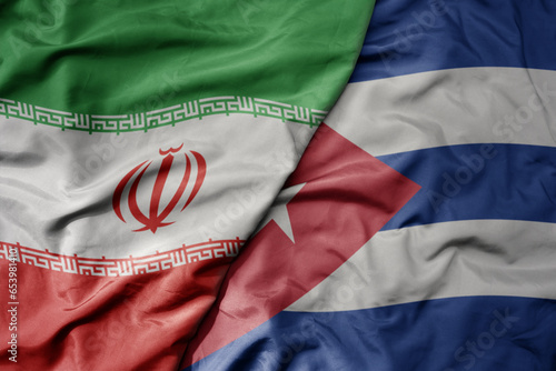 Photography big waving realistic national colorful flag of iran and national flag of cuba