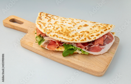 Tableau sur toile Italian piadina sandwich with prosciutto, rocket, and Italian cheese stracchino