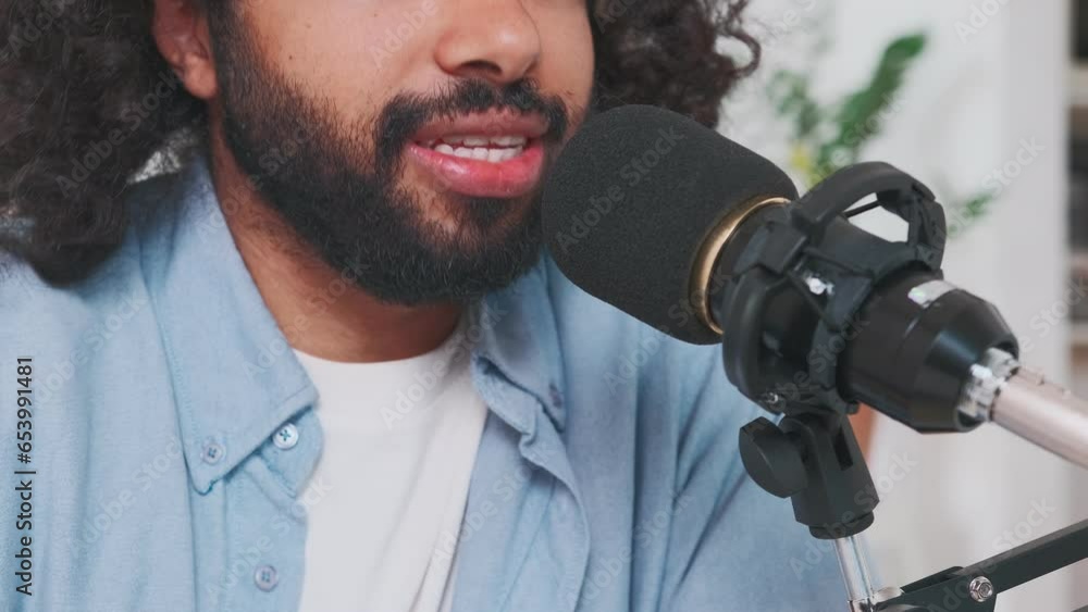 Young confident Arabian man radio host with beard and curly hair speaks