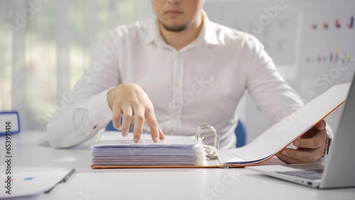 Businessman working looking at files.