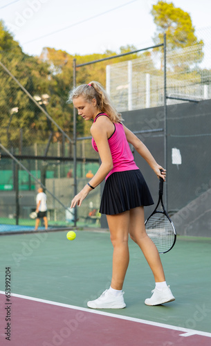 Tennis game - girl getting ready to hit the ball with racket. High quality photo © JackF