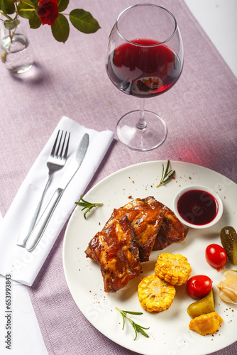 Grilled pork ribs with rosemary, corn and berry sauce