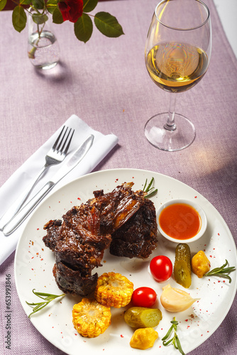 roasted lamb ribs with rosemary and spices on a white plate