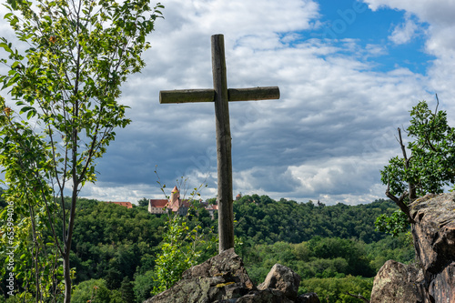 Landscape view from hilltop with cross and Castle Veveri in the background, Czech Republic