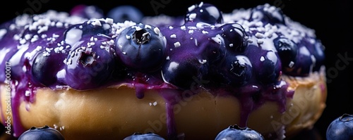 A closeup shot captures a freshly baked blueberry bagel, its puffy exterior showcasing bursts of vibrant purpleblue hues. Specks of sweet, juicy blueberries peek through, hinting at the photo
