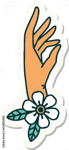 sticker of tattoo in traditional style of a hand and flower