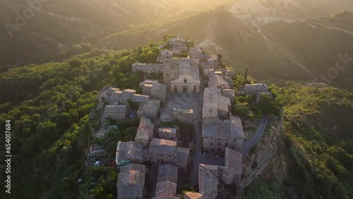 Civita di Bagnoregio, aerial view at sunrise, located on top of a volcanic tuff hill overlooking the Tiber river valley, province of Viterbo, Lazio, Italy