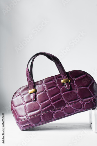 Close up of handmade purple embossed calfskin leather handbag, handmade leather bowler bag, artisan purple leather handbag with a short strap