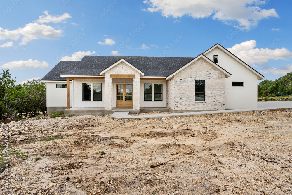 © Allison - a white stone house still under construction and unfinished