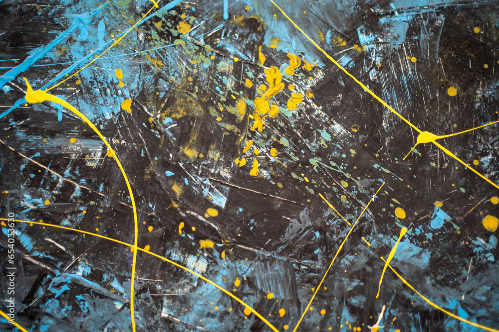 Wall with blue and yellow paint splashes. Dark canvas with abstract ...