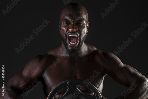 Canvas-taulu Intense workout screaming man with weights