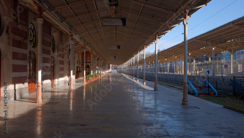 Early morning at the empty railway station. Action. Sunshine on the empty platform. photo