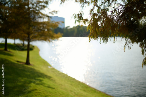 THE WOODLANDS, TEXAS - JULY 24th 2023: background settings for outdoor portraits by Lake Woodlands. The lake waters are tranquil, the fall colors are spectacular, there are hidden paths and benches