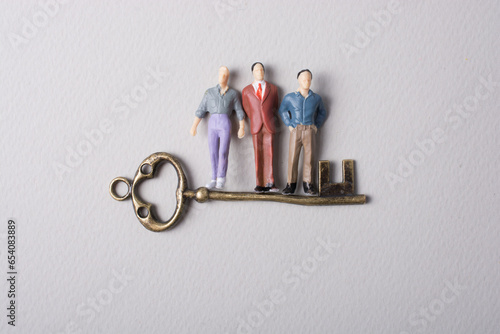 Tiny figurine of man model and retro key photo