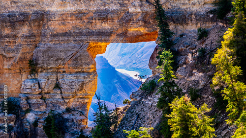 The Colorado River is visible through Angels Window at Cape Royal on the North Rim of Grand Canyon National Park, Arizona, USA