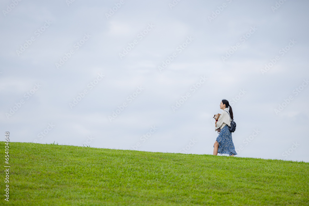 Woman with her dachshund dog walking in the park Woman with her dachshund dog walking in the park