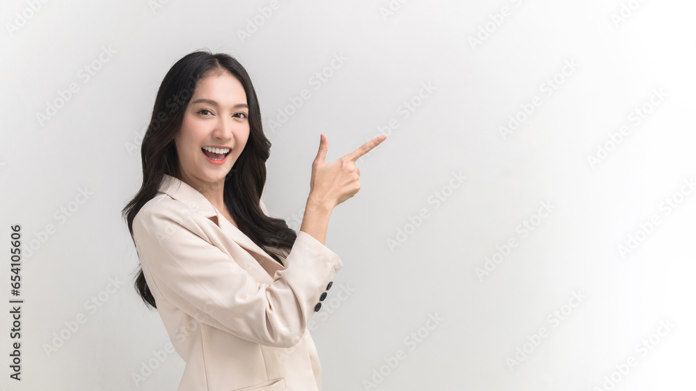 Portrait photo of young lively active Asian woman pointing at empty copy space can use for product advertising and marketing message for customer. Studio shot on white background. Portrait photo of young lively active Asian woman pointing at empty copy space can use for product advertising and marketing message for customer. Studio shot on white background.