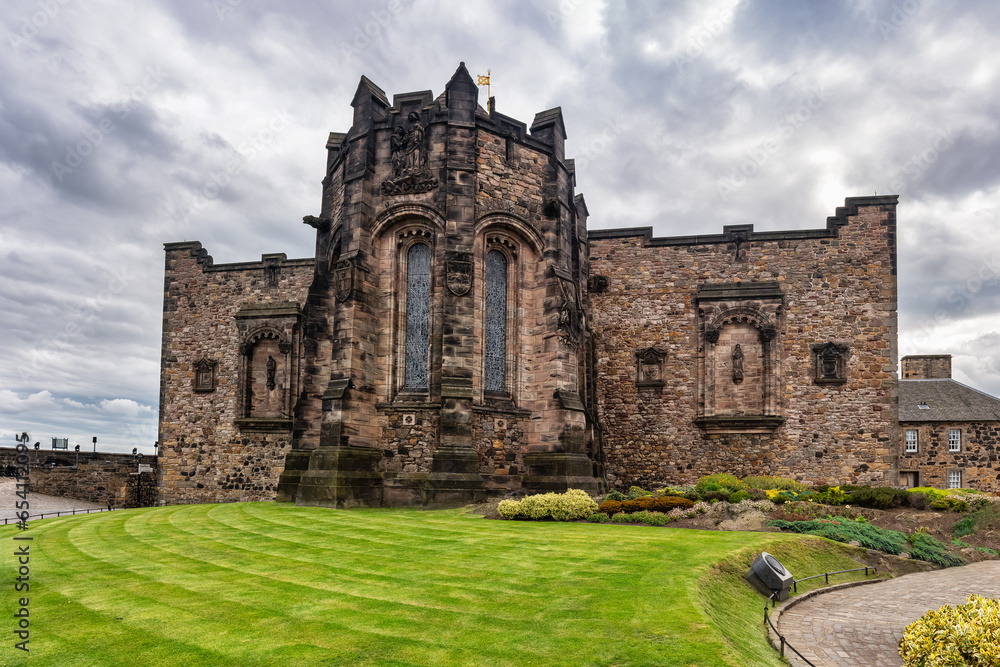 Wall and medieval buildings with stone church in Edinburgh Castle, Scotland, UK.