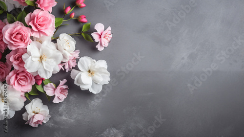 A bunch of pink and white flowers on a gray background