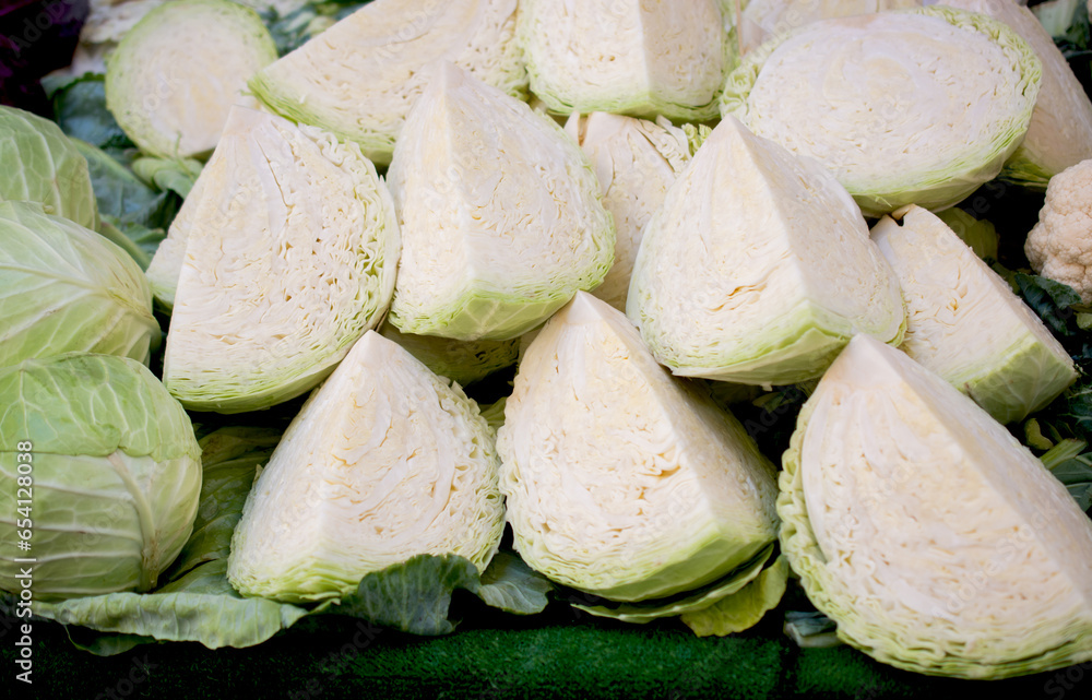 Fresh organic heads of cabbages cut in pieces on the farmers market. Fresh organic heads of cabbages cut in pieces on the farmers market.