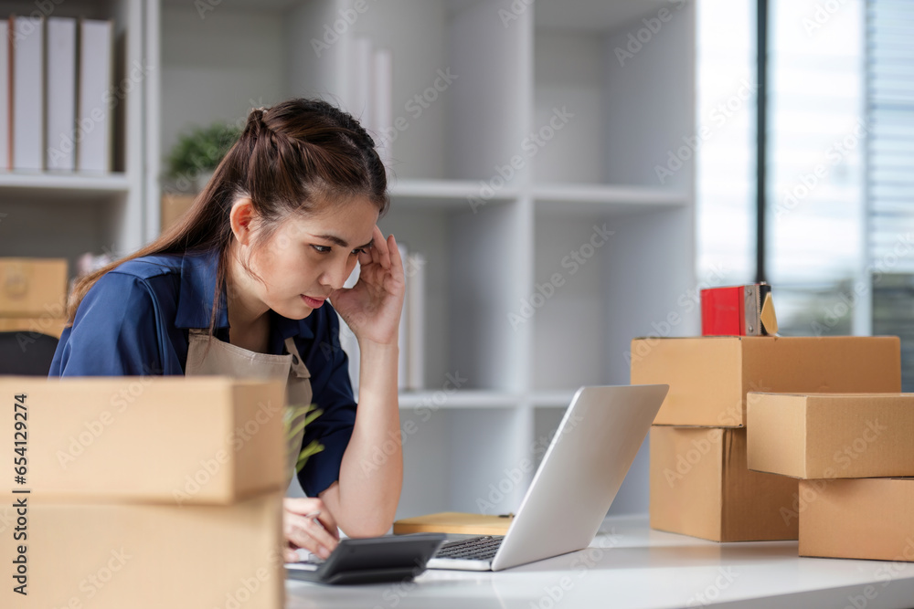 SME business entrepreneurs who conduct online sales businesses Sitting stressed while checking product management documents. SME business entrepreneurs who conduct online sales businesses Sitting stressed while checking product management documents.