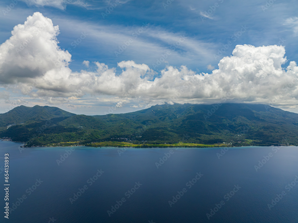 Tropical island with deep blue sea. Blue sky and clouds. Camiguin, Philippines. Tropical island with deep blue sea. Blue sky and clouds. Camiguin, Philippines.
